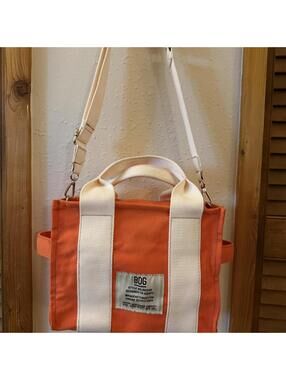 BDG Urban Outfitters orange canvas tote bag with white straps
